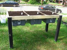 an old table is filled with composted planters and dirt in the yard