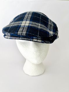 "Great cap for your guy! This is a really well made 100% wool cap made in Donegal Ireland. The blue gray combination is very handsome. The interior of the cap is top quality black, quilted material made to keep you warm. The label inside states, \" The fabric has the colors and character of our countryside. Ruggedness to wear well. Softness for comfort. Joy and health to you who wear this.\" That says it all! Complete with an Irish blessing! Excellent pre owned condition. Perfect gift for husban Navy Wool Cap, Navy Flat Cap For Winter, Navy Wool Casual Hat, Casual Navy Wool Hat, Blue Wool Cap, Donegal Ireland, Plaid Flats, Wool Caps, Quilt Material