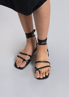 Color: Black Soft leather sandal Wrap around ankle strap Front toe detailing Padded insole Low platform 100% Leather Upper Leather Outsole By Mari Giudicelli. Made in Brazil Black Leather Toe Loop Sandals, Leather T-strap Sandals With Toe Loop And Rubber Sole, Mari Giudicelli, Black Leather T-strap Sandals With Toe Loop, Black Adjustable T-strap Sandals With Leather Footbed, Soft Leather Sandals, Black Leather T-strap Sandals With Buckle Closure, Paris Woman, Toe Ring