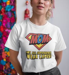 "Looking for the perfect gift for your amazing mom this Mother's Day? Look no further than our Mother's Day t-shirt! This soft and comfortable tee is made from high-quality materials and features a beautiful design that reads \"Mom. Not All Super Heroes Wear Capes .\" It's the perfect way to show your mom how much you appreciate her and all that she does for you. This classic unisex jersey short sleeve tee fits like a well-loved favorite. Soft cotton and quality print make users fall in love with it over and over again. These t-shirts have-ribbed knit collars to bolster shaping. The shoulders have taping for better fit over time. Dual side seams hold the garment's shape for longer.  .: 100% Airlume combed and ringspun cotton (fiber content may vary for different colors) .: Light fabric (4. Mothers Day Tshirt Ideas, Not All Superheroes Wear Capes, All Superheroes, Mom Tshirt, Mothers Day T Shirts, Mothers Day Shirts, Super Mom, 7th Birthday, Super Heroes