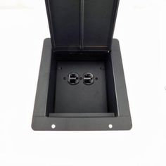 the inside of a black box with two small holes in it on a white surface