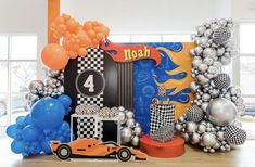 an assortment of balloons and decorations for a race car themed birthday party