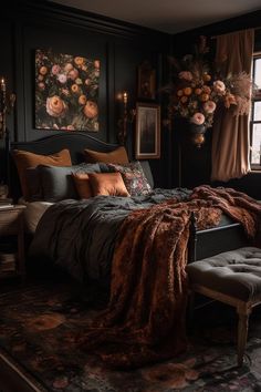 a bedroom with black walls and floral paintings on the wall above the bed, along with an upholstered bench