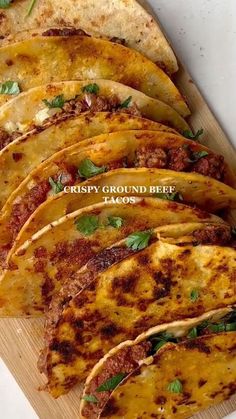 several tortillas on a cutting board with cheese and herbs in the middle, ready to be eaten