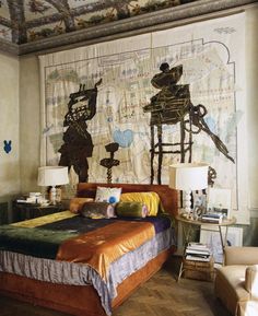 a bed room with a neatly made bed and a large map on the wall behind it