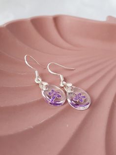 These beautiful, handmade silver earrings with real purple dye elderflowers are the perfect gift for her, whatever the occasion may be. These lightweight and stylish silver earrings are the must have this season. Ideal present for women to celebrate anniversary, birthday or wedding. Teardrop Earrings With Flower Charm, Silver Pressed Flowers Drop Earrings, Elegant Silver Earrings With Pressed Flowers, Silver Pressed Flowers Earrings For Gift, Sterling Silver Teardrop Earrings For Gift, Elegant Purple Pressed Flower Earrings, Silver Drop Earrings With Pressed Flowers, Pressed Flowers Sterling Silver Drop Earrings, Teardrop Jewelry With Pressed Flowers