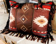 a brown and red pillow sitting on top of a stone fireplace