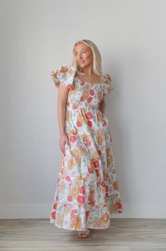 Introducing our smocked puff sleeve flower printed maxi dress! With a square neckline, puff sleeves, and a smocked top, it offers both style and comfort. Includes hidden side seam pockets and a tiered skirt. Perfect for any occasion, this dress is a must-have for your wardrobe. puff sleeves floral print tiered maxi length colorful lined pockets true to size 100% cotton model is wearing a small Square Neck Ruched Maxi Dress For Brunch, Floral Print Puff Sleeve Maxi Dress For Brunch, Puff Sleeve Maxi Dress With Floral Print For Brunch, Floral Square Neck Smocked Dress For Garden Party, Spring Maxi Dress With Smocked Bodice And Square Neck, White Smocked Dress With Floral Print And Square Neck, Square Neck Maxi Dress With Smocked Back For Brunch, Casual Floral Print Maxi Dress With Puff Sleeves, Square Neck Smocked Dress With Floral Print For Brunch