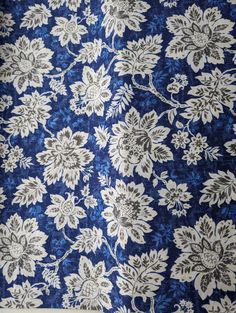 a blue and white floral pattern on fabric