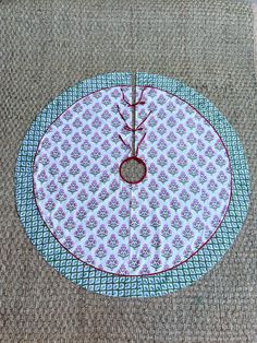 the table cloth has been stitched together to make a circular design with red thread on it