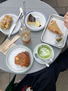 a table topped with plates and bowls filled with different types of desserts on top of it