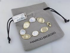 Available for order. (Orders Placed today will ship in approximately 4-6 weeks.) 18k yellow gold & white mother of pearl bracelet 18k Yellow Gold 7 in White Mother of Pearl 12MM Lunaria Stations 6.97 Grams Made in Italy NAGI Jewelers is an authorized Marco Bicego retailer Designer Polished Gold Bracelet As Gift, Designer Gold Bracelet With Polished Finish As Gift, Formal Yellow Gold Mother Of Pearl Jewelry, Luxury Oval Mother Of Pearl Jewelry, Modern Yellow Gold Pearl Bracelet Gift, Modern Yellow Gold Pearl Bracelet As Gift, Modern Yellow Gold Pearl Bracelet For Gift, Modern Yellow Gold Pearl Bracelet, Luxury Oval Gold Bracelet As Gift