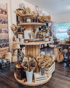 a room filled with lots of different types of items on shelves and wooden crates in the middle