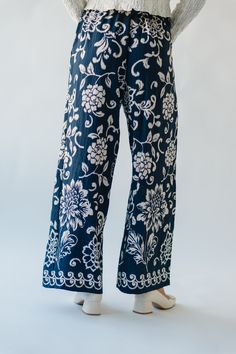 Get ready to blossom in our Halloran Floral Wide Leg Pant in Navy. With its eye-catching floral pattern and comfortable wide leg design, these pants are perfect for any occasion. Embrace your playful side and stand out from the crowd with these quirky and fun pants! Details self/lining: 85% rayon + 15% nylon Fabric Care Guide Here Sizing & Fit Measurements are approximate and taken while laying flat across the front. Not doubled. small: inseam= 28"; waist = 14"; length = 40" medium: inseam = 28. Cotton Floral Print Ankle-length Pants, Blue Floral Embroidered Wide Leg Bottoms, Patterned Floral Print Bottoms For Vacation, Floral Print Patterned Bottoms For Vacation, Floral Print Cotton Pants, Cotton Bottoms With Floral Print For Loungewear, Floral Print Cotton Bottoms, Patterned Floral Print Cotton Pants, Patterned Cotton Bottoms With Floral Print