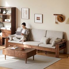 a woman sitting on a couch using a laptop