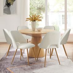 a dining room table with white chairs and a potted plant on the top shelf