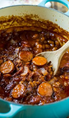 a blue pot filled with beans and sausage