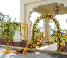 an outdoor ceremony with yellow flowers and decorations