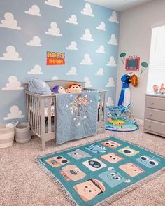 a baby's room with blue walls and clouds on the wall