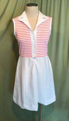 "This is a cute vintage dress from the early 70s. No Brand label only a care & size tag. Tagged a size 14. The bust measures 36\", waist 30\", see measurements below, but it would look best on a slightly smaller bust & waist. Made of a pink & white polyester. The dress is a zip & button front shirt dress. It buttons to the waist & below that is a short nylon zipper. It is sleeveless with a lapel style collar. The top half is pink & white horizontal stripe & the skirt Vintage White Sleeveless Dress For Summer, White Retro Sleeveless Spring Dress, White Vintage Sleeveless Dress For Summer, White Vintage Sleeveless Summer Dress, Vintage White A-line Sleeveless Dress, White Retro Sleeveless Dress, White A-line Retro Vintage Dress, White Sleeveless Mod Dress, Sleeveless Lined Vintage Dress