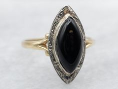 This vintage solitaire ring is actually quite versatile! Bold and sleek, the perfectly polished black onyx marquise is a subtle statement against the white gold. A classic, this easy-to-wear ring is narrow and tapered in the back and sits low to the finger, making it comfortable to wear.Metal: 14K Yellow and White GoldGem: Black OnyxGem Measurements: 12.4 x 5.9 mm, Marquise Cut Ring Size: 6Marks: “BIRKS 14K” Stamped on the inside band Marquise Cut Rings, Ring Marquise, Black Onyx Ring, Watch Chain, Ring Black, Onyx Ring, Marquise Cut, Pearl Pendant, Beaded Chain