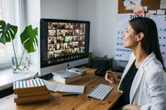 a woman sitting at a desk in front of a computer with pictures on the screen