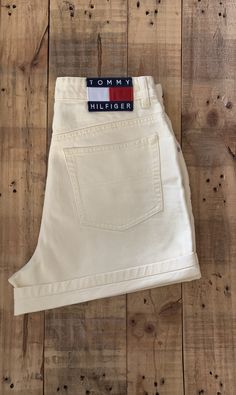 "High waisted 90's denim shorts. Made by Tommy Hilfiger in pale yellow denim wash with classic large patch Tommy Hilfiger logo. Shorts are in excellent clean condition. Logos still bright and crisp in color. Wear as is or roll them up as shown in photos. Perfectly worn in with light naturally distressed character. Measurements (taken zipped or buttoned up and laid comfortably flat) inches x 2 for total circumference (inches) Tag Size 8 Tommy Hilfiger 100% Cotton Waist 29\" Hips 41\" Length 15\" Levis Jeans High Waisted, Levi High Waisted Shorts, Tommy Hilfiger 90s, Levis Mom Jeans, 90s Tommy Hilfiger, Yellow Denim, Tommy Hilfiger Logo, Tommy Hilfiger Shorts, 90s Denim