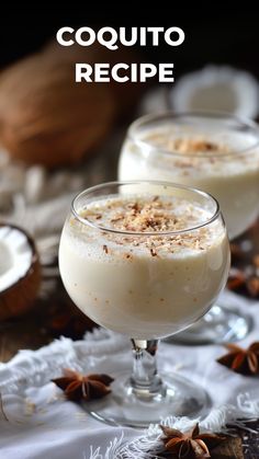 two glasses filled with dessert sitting on top of a table next to nuts and cinnamons