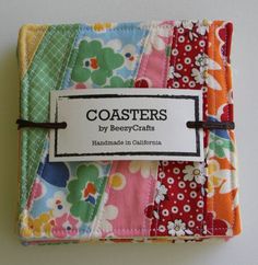 a close up of a patchwork quilt with a tag on it that says coasters