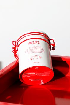 a red tray with a white bucket on it