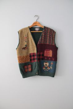 vintage rare essential cabin/cottage core aesthetic dark autumn color warmest wool intarsia knitwork vest. featuring cutest bear, duck and farm house in moody autumn front and pine green back. embossed flower buttons in antiqued brass.  100% wool   Made by Woolrich  Fits best like oversize or large (tag vintage size L): 16" shoulders 44" bust 22" length Condition: excellent! ✮ shop our selection of vintage knitwear here: https://etsy.me/3XGKMBb ✮ shop The Veiled Ghost handmade jewelry: https://etsy.me/32CDNCC ✮ shop Adrian Company Vintage: https://etsy.me/3u2Ewbi Knitwear Aesthetic, Moody Autumn, Etiquette Vintage, Cabin Cottage, Vintage Knitwear, Artsy Outfit, Dark Autumn, Cottage Core Aesthetic, Wool Vest