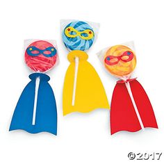 three different colored lollipops are in the shape of superhero masks and capes