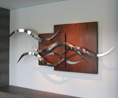 a metal sculpture is mounted on the wall