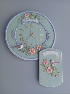 a clock with flowers and birds on it next to a tag that says too pretty