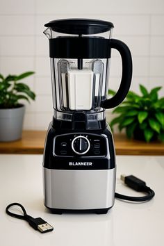 a blender sitting on top of a counter next to a plant