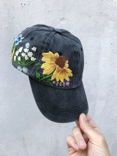 Hand Embroidered Hat is the best gift for her! 🌿 PLEASE NOTE THIS HAT IS READY TO SHIP🌿 Color: a black baseball cap. Design: hand embroidered echinacea with wildflowers. Cap size (head circumference): 55 - 62 cm. GET 10% OFF YOUR 1ST ORDER! Get a 10% off coupon code for our Etsy shop by signing up to our mailing list eepurl.com/gefZy5 CHECK OUR OTHER ACCESSORIES 🌸More Baseball hats: https://www.etsy.com/shop/KazkovaEmbroidery?ref=seller-platform-mcnav&section_id=25392998 🌿Kids Baseball h Embroidered Adjustable Trucker Hat, Embroidered Trucker Hat With Curved Brim, Embroidered Dad Hat For Summer, Embroidered Dad Cap For Summer, Embroidered Baseball Cap One Size Fits Most, Embroidered Brimmed Baseball Cap, Embroidered Summer Dad Hat, Embroidered Visor Hat, Embroidered Cap For Festival