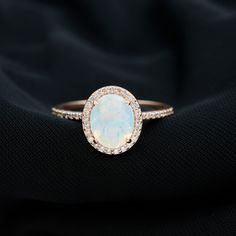 Product Details Make a grand gesture of love with this magnificent oval shaped ring. The center stone is an awe-inspiring Ethiopian opal surrounded by a halo and side stones of round brilliant cut Diamond stones in an accent setting. Perfect for surprising your beloved, this Ethiopian opal ring is a symbol of your deep feelings. Expertly crafted from solid gold, this ring will be treasured for years to come. Product Information SKU SHP-RINGS0821199160 Width 7.5 mm Height 11.5 mm Weight 2.39 gm (Approximate) ETHIOPIAN OPAL INFORMATION No.of Stones 1 Pieces Total Weight 1.33 Carat (Approximate) Dimension(approx) Oval-8X10 mm-1 Pcs Color Rainbow Cut Brilliant Shape Oval Setting Type Prong-Setting Quality Grade AAA DIAMOND INFORMATION No.of Stones 40 Pieces Total Weight 0.52 Carat (Approximate Opal Ring With Diamonds, Heirloom Style Ethiopian Opal Oval Ring, Elegant Ethiopian Opal Ring In Oval Cabochon, Gold Opal Ring With Halo Design, Oval Shape, Classic Halo Engagement Ring, Elegant Ethiopian Opal Ring, Hallmarked, Stone Ring Design, Elegant Ethiopian Opal Ring, Oval Cabochon, Ethiopian Opal Ring