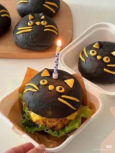 a cat burger with a lit candle in it