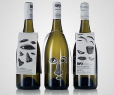 three bottles of wine with faces on them