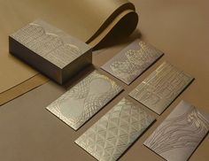 five pieces of metallic paper with designs on them