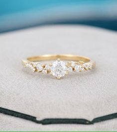 a diamond ring sitting on top of a cushion