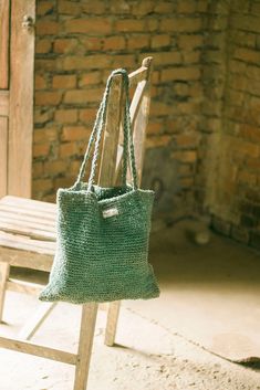 "Sustainable Knitted Bag made of 100% Raw Hemp Uma \"उमा \" : name of a Hindu Goddess \"Parvati\", a mother The word Uma in Sanskrit derives from a name of Hindu Godddess, Parvati who is worshipped as a motherly figure. Ma also means mother in Nepali and Sanskrit.   Uma has been knitted with the same love that a mother gives to her child. The plaited handles alone remind us of the childhood hairstyle our mothers would give us.   The bag has one spacious main compartment and is supported with two Everyday Knitted Straw Tote Bag, Daily Use Handwoven Yarn Shoulder Bag, Handwoven Yarn Tote Shoulder Bag, Everyday Woven Yarn Bags, Hand Knitted Yarn Tote Shoulder Bag, Eco-friendly Handwoven Yarn Bag, Eco-friendly Crochet Bag For Everyday Use, Natural Hand Knitted Everyday Shoulder Bag, Yarn Shoulder Bag With Braided Handles For Everyday Use