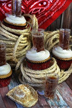 some cupcakes and other dessert items on a table with a red bandanna