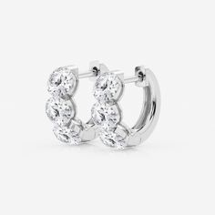 pair of white gold earrings with round brilliant cut diamonds on the hoop, set in 18k white gold