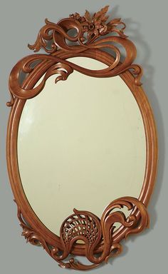 an ornate mirror is shown on the wall