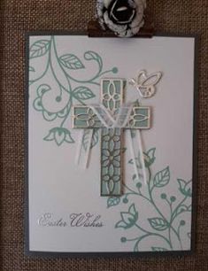 a card with a cross and flowers on it