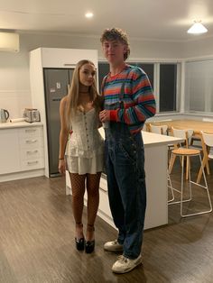 a man standing next to a woman in a kitchen