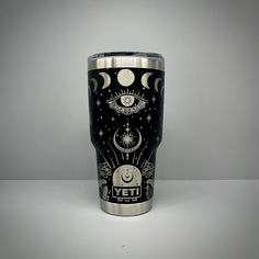 a stainless steel tumbler with an image of the moon, stars and planets on it