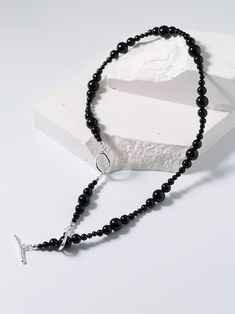 Unique fashion journey with our gradient black onyx chain. Combines sizes of black onyx beads (3mm to 8mm) for a striking and versatile accessory. Features gradient design, clavicle chain fit, and safety buckle for stylish and safe wear. Elevate your style with our black onyx clavicle chain for a sophisticated look. Metal: Recycled Sterling Silver Plated On Brass Gemstone:Black Onyx Necklace length 370-440mm Weight: 21.5g Elegant Black Beaded Necklaces With Gemstone Beads, Elegant Black Beaded Necklaces With Polished Beads, Trendy Black Beaded Necklaces With Round Beads, Elegant Black Beaded Necklace With Gemstone Beads, Minimalist Black Beaded Choker Necklace, Elegant Black Beaded Necklace With Polished Beads, Elegant Black Onyx Beaded Necklace, Trendy Black Beaded Necklace Gift, Minimalist Black Gemstone Beaded Necklaces