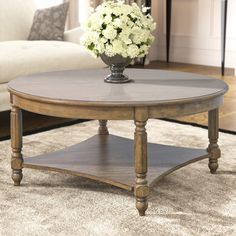 a coffee table with flowers on top in a living room